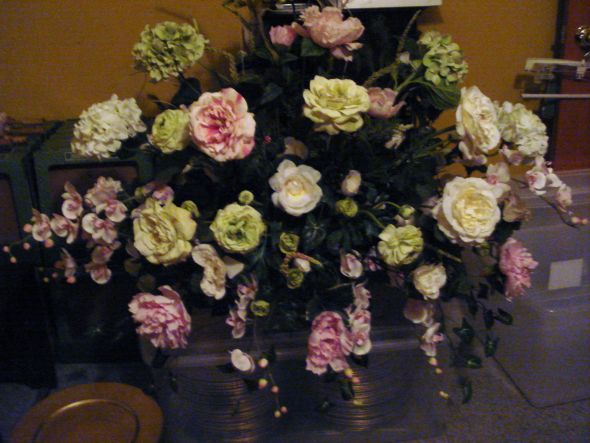 I have this big flower arrangement in a rectangler gold vase with pink and 