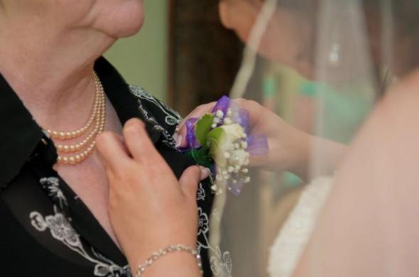 Pinning my mom's corsage wedding corsage blue purple ivory flowers 