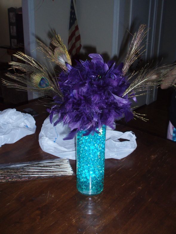 Centerpiece trials for peacock themed evening wedding wedding centerpiece