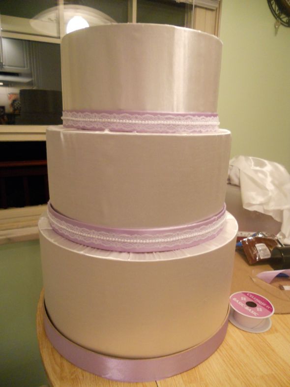 wedding cake with purple ribbon and lace
