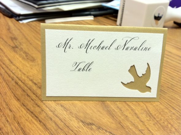 Gold escort cards with bird cutout and message inside wedding gold white