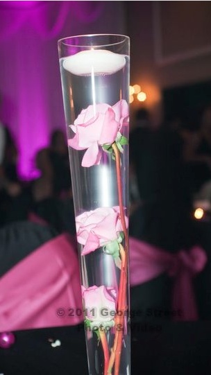 I have 16 Wedding centerpieces for sale Tall vases with 3 pink roses in 