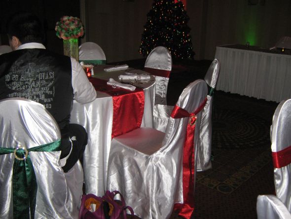 the red and green sashes on the chairs the runners and the gold rhinestone