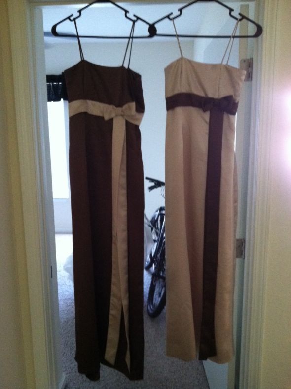 The brown dress is slightly larger and longer than the champagne dress