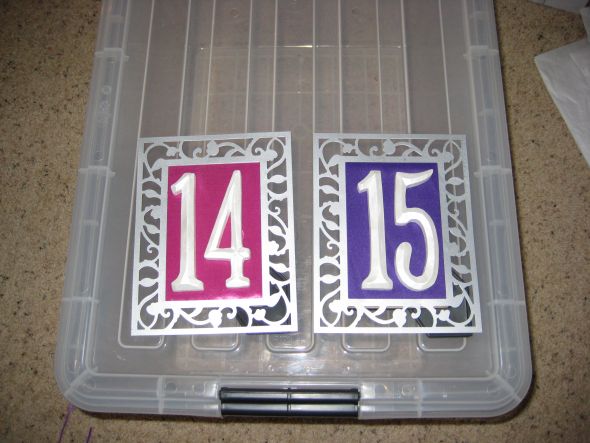 Items from purple magenta and orange wedding wedding table numbers sign 