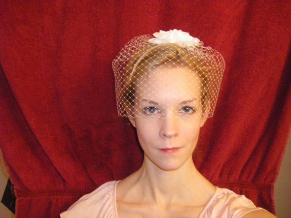I'm wearing a bird cage veil for the ceremony and a big facsinator at the