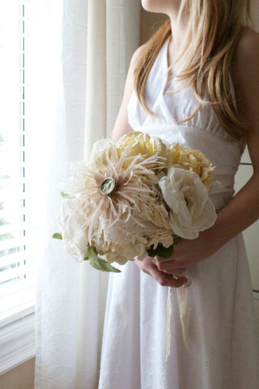 An idea of my bouquet, only with red broaches. I love the paper machete flowers.