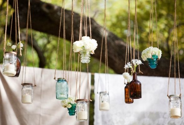 Arch idea hanging mason jars with candles flower buds